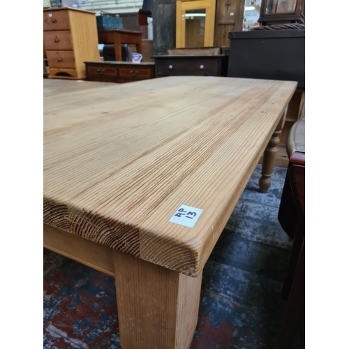 629 - A solid pine rectangular farmhouse dining table - measuring approx. 183cm x 91cm x 78cm