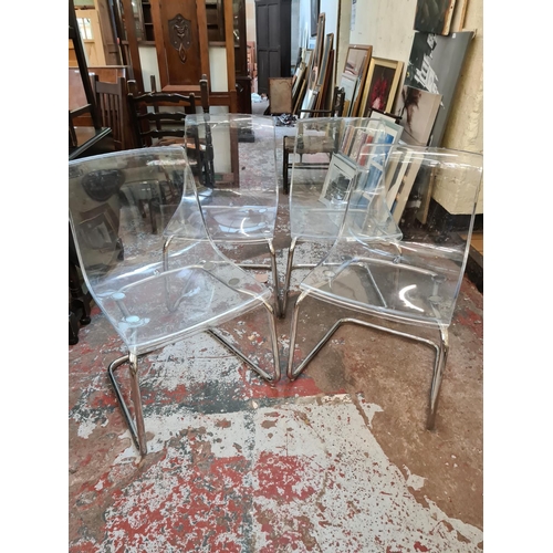 645 - Four contemporary perspex dining chairs on chrome supports