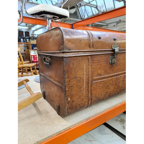 652 - A vintage brown metal travel trunk