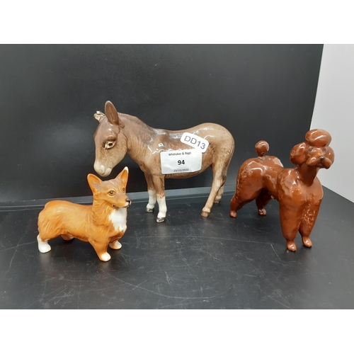 94 - Three Beswick figurines to include donkey, corgi and brown poodle (see condition report)