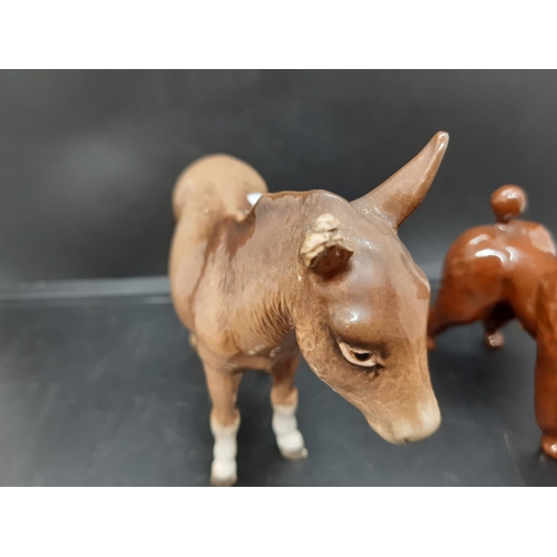 94 - Three Beswick figurines to include donkey, corgi and brown poodle (see condition report)