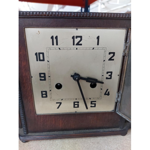 288 - A 1930s oak cased chiming mantel clock with silvered dial