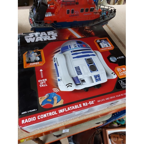 297 - A large quantity of toys and games to include a boxed Star Wars radio control inflatable R2-D2, Mono... 