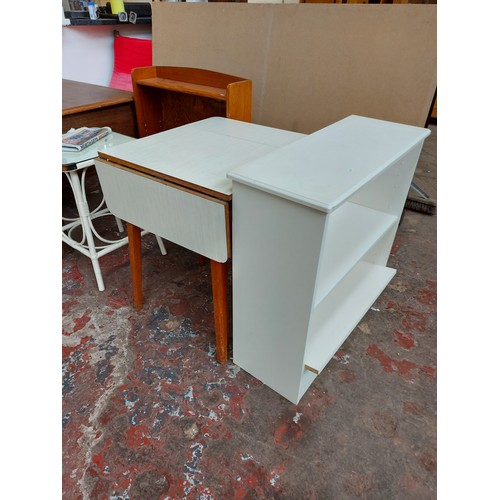 550 - Two items to include a white melamine drop leaf kitchen table and a white laminate freestanding book... 