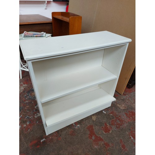 550 - Two items to include a white melamine drop leaf kitchen table and a white laminate freestanding book... 