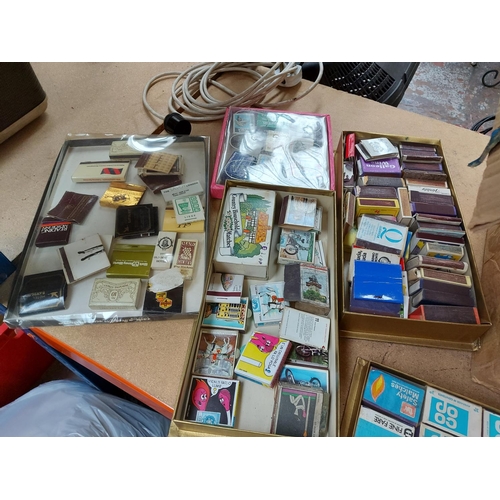 322 - Four boxes containing a large collection of vintage match boxes