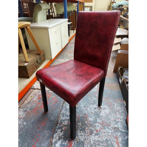 657 - Four Stefix retro style burgundy leatherette dining chairs