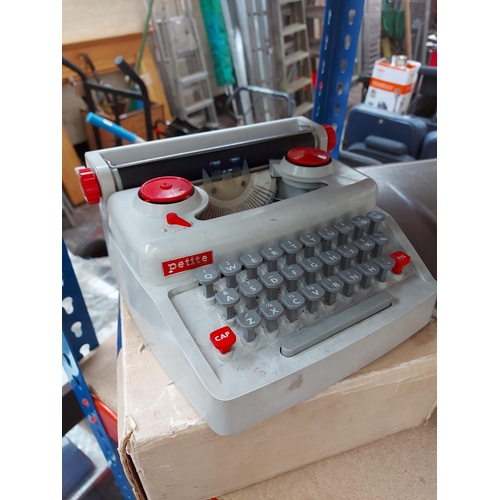 330 - Two type writers to include a boxed Petite and a cased imperial type writer