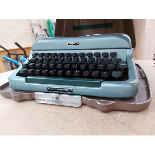 330 - Two type writers to include a boxed Petite and a cased imperial type writer