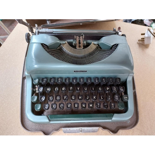 330 - Two type writers to include a boxed Petite and a cased imperial type writer