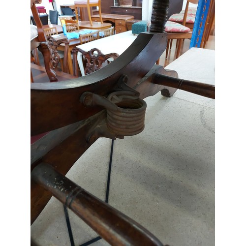 658 - An early 20th century American mahogany rocking chair