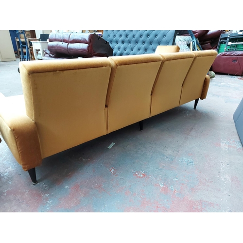 676 - A mid 20th century G Plan mustard upholstered four piece lounge suite comprising four seater sofa, t... 