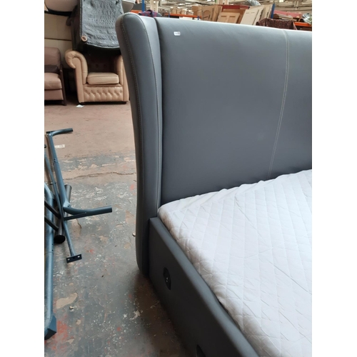 690 - A modern grey leatherette king size TV bed with fitted LG TV, remote and Dreams Readymatt Supreme me... 