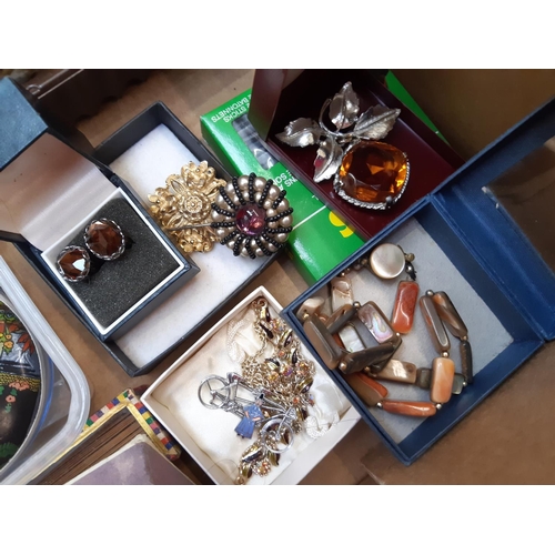 162 - A box of costume jewellery to include necklaces, brooches, cufflinks, boxed folding hand fan, Church... 