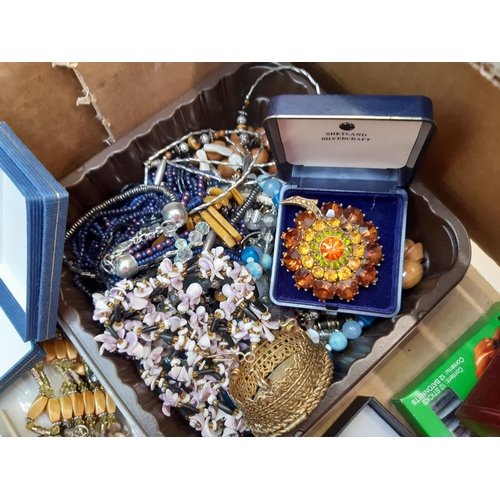 162 - A box of costume jewellery to include necklaces, brooches, cufflinks, boxed folding hand fan, Church... 