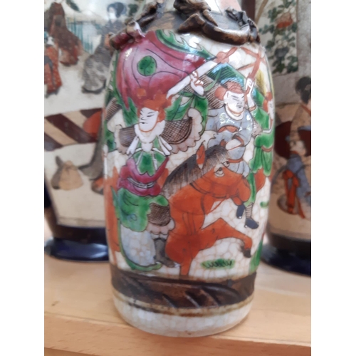 175 - A pair of 19th century Japanese Meiji period Satsuma vases depicting figures in oriental garden toge... 