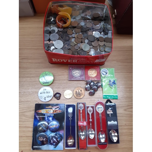 181 - A tin containing a collection of mixed items to include foreign and British coins, as new Doctor Who... 