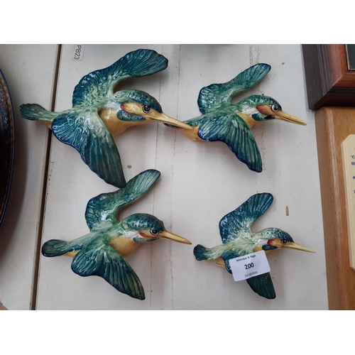 200 - Six ceramic figurines to include a set of four graduating Beswick flying Kingfishers, Poole Seal and... 