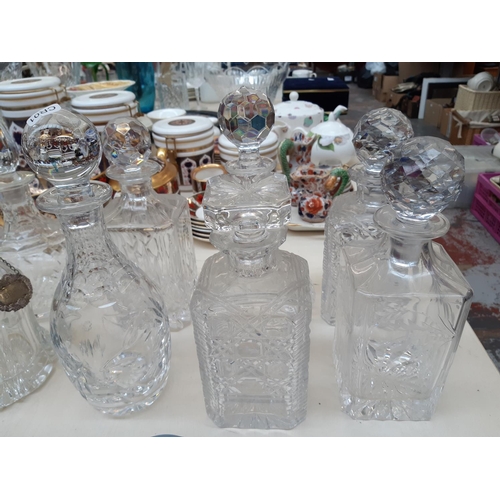 207 - Nine glass and cut crystal decanters to include one spherical Royal Doulton example together with a ... 