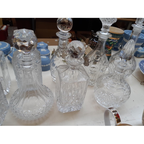 207 - Nine glass and cut crystal decanters to include one spherical Royal Doulton example together with a ... 