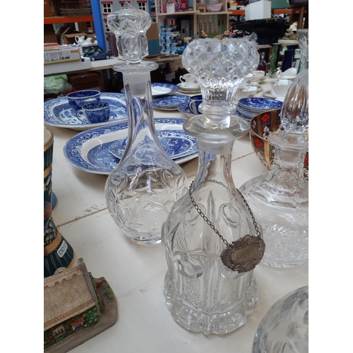 207 - Nine glass and cut crystal decanters to include one spherical Royal Doulton example together with a ... 