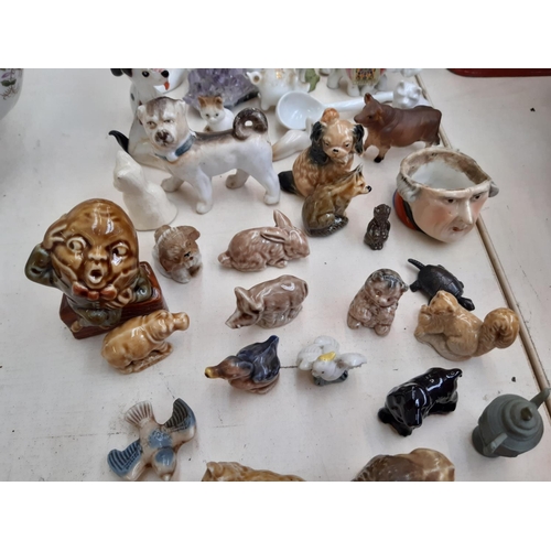 216 - A collection of miniature ceramic ornaments to include Wade Humpty Dumpty, crested ware etc.