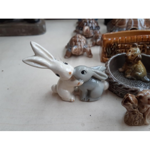 221 - A collection of Wade ceramic ornaments to include tortoises, rabbits, parrot etc.