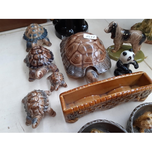 221 - A collection of Wade ceramic ornaments to include tortoises, rabbits, parrot etc.