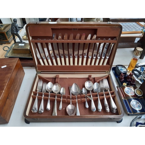 228 - A vintage oak cased part canteen of cutlery