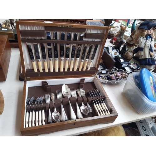 229 - A vintage oak cased part canteen of cutlery