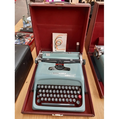 233 - A brown cased Olivetti studio 44 typewriter with instruction manual