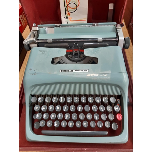 233 - A brown cased Olivetti studio 44 typewriter with instruction manual