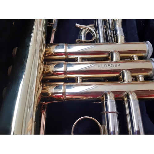 240 - A cased brass and rose brass Artemis student Cornet fitted with AC4B mouthpiece