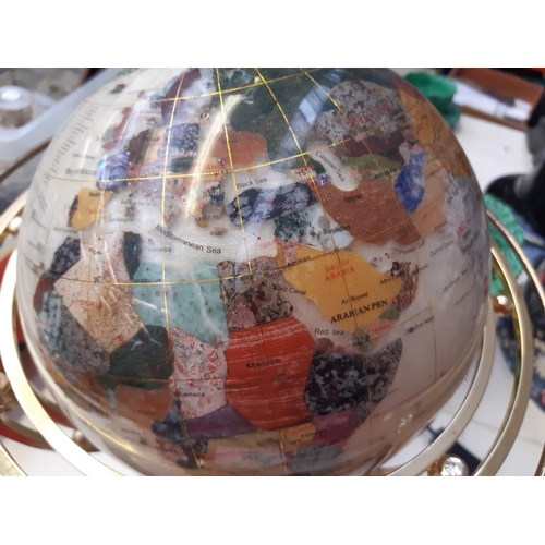 244 - An illuminating and rotating modern globe made using semi-precious stones on brass base