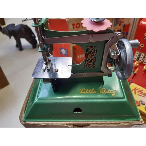 247 - A vintage boxed Little Betty child's tin plated sewing machine