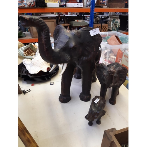 249 - A set of three graduating leather elephant figurines, the tallest measuring 47cm high x 44cm long - ... 