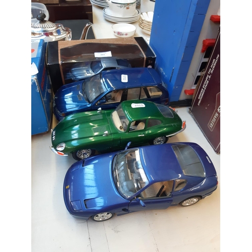 263 - A collection of Four die cast vehicles to include Burago Ferrari 456 GT, Burago Jaguar E-Type, BMW X... 