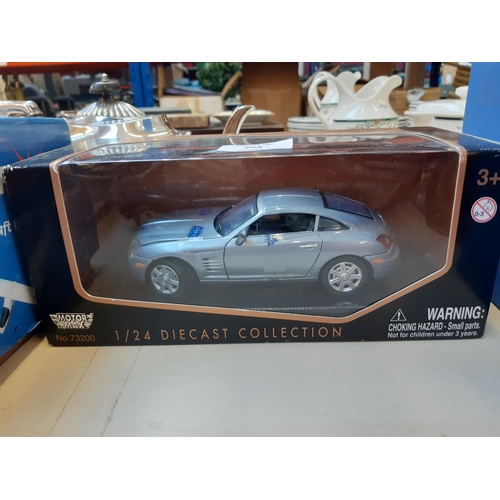 263 - A collection of Four die cast vehicles to include Burago Ferrari 456 GT, Burago Jaguar E-Type, BMW X... 