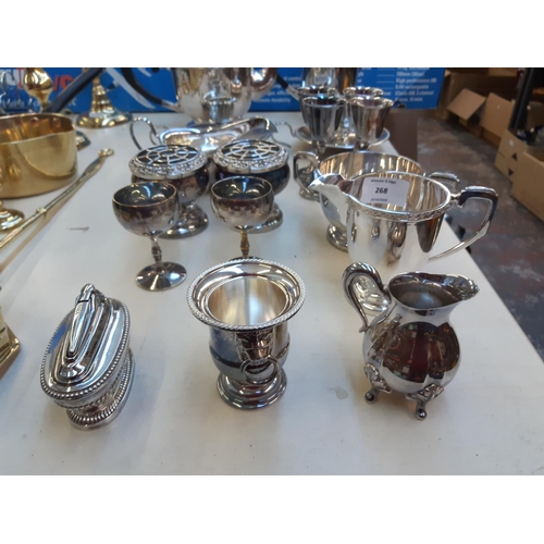 268 - A collection of mixed metalware to include a brass chestnut roaster, brass pan, pair of brass candle... 