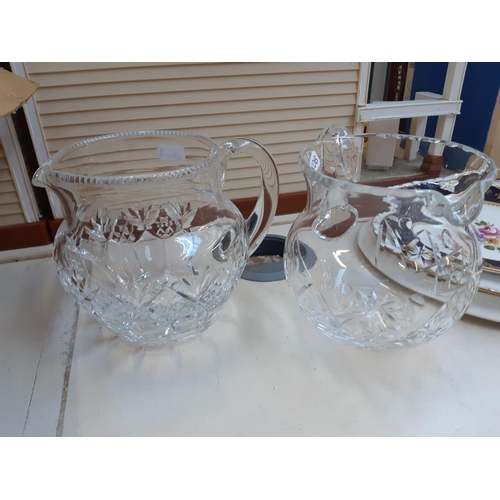 271 - A collection of glassware to include a tri footed cut glass fruit bowl, cut crystal water jug, etc.