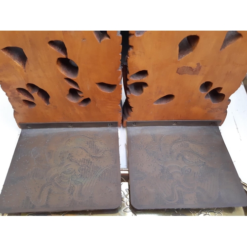 275 - A collection of oriental ornaments to include a pair of carved teak wood book ends with nautical sce... 