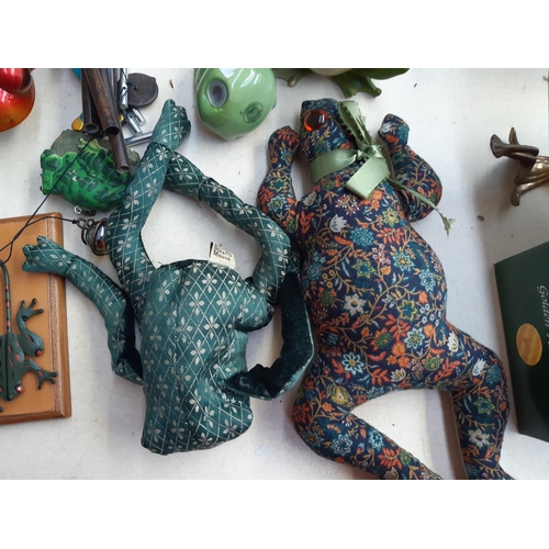 281 - A collection of frog ornaments to include ceramic, metal, wooden and fabric examples