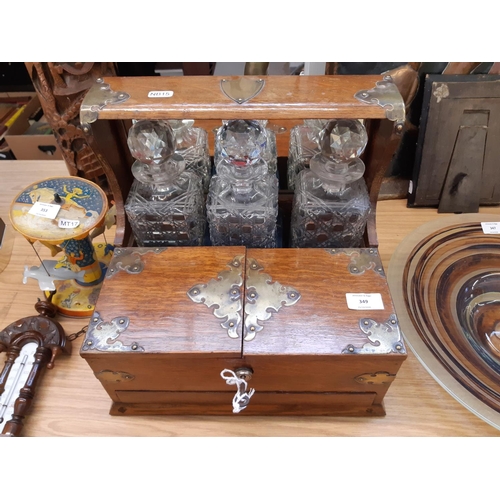 349 - A good quality Victorian oak tantalus with brass details, three cut glass decanters and inner storag... 