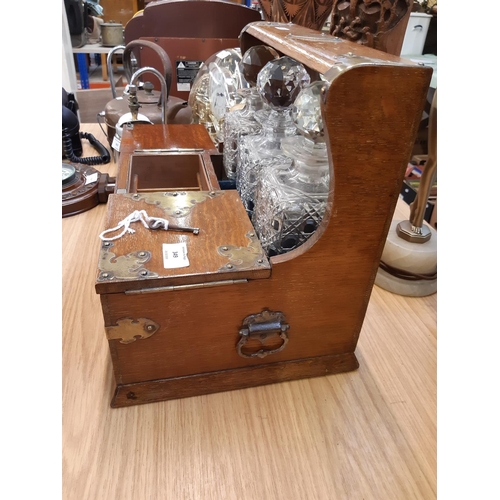 349 - A good quality Victorian oak tantalus with brass details, three cut glass decanters and inner storag... 