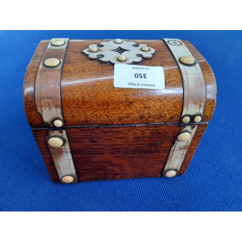 350 - A 19th century French oak tea caddy in the form of a treasure chest with ivory button decoration