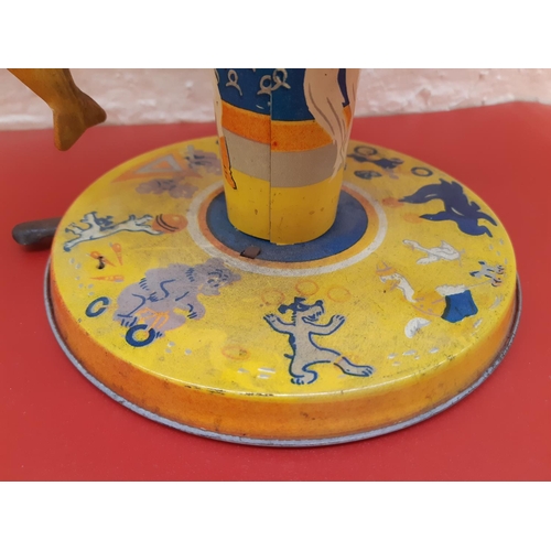 353 - A vintage tin plated miniature child's toy in the form of a fairground ride