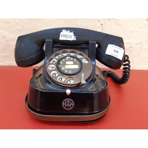 358 - An antique Bell Telephone MFG Company black and gold painted dial up telephone