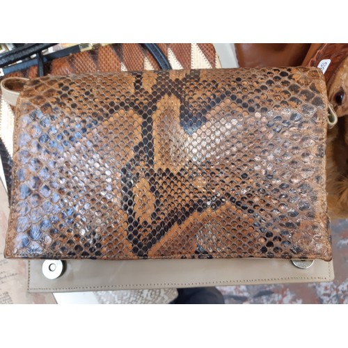 168 - A collection of various vintage ladies handbags and purses to include a crocodile skin effect evenin... 