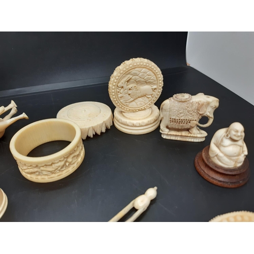 33 - A large collection of well detailed antique carved ivory figurines and ornaments to include netsukes... 