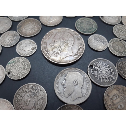 36 - A collection of pre 1920 presumed silver world coins to include 1869 Leopold II Belgian 5 franc coin... 